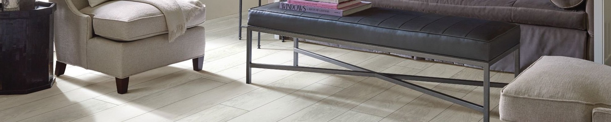 beige armchairs and black coffee table in living room with white hardwood flooring from Perge Carpet & Floors in Wheaton, MD