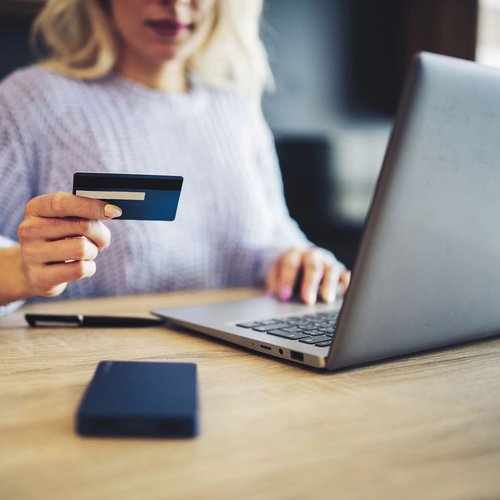 person using laptop to pay online with credit card from Perge Carpet & Floors in Wheaton, MD | From facts to fashion, we make beautiful floors easy! Perge Carpet & Floors in Wheaton | Perge Carpet & Floors | Wheaton  |  301-942-3330