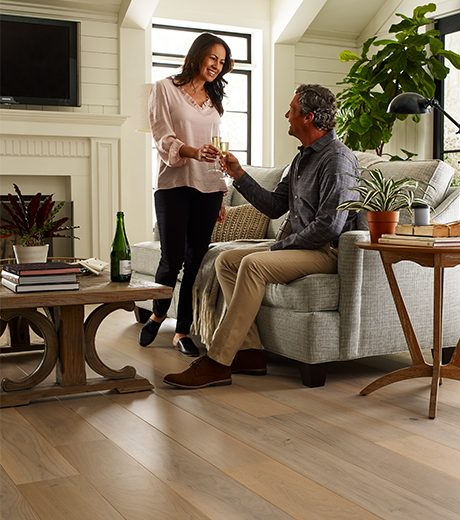 people in living room with hardwood flooring from Perge Carpet & Floors in Wheaton, MD