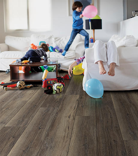 kids playing in room with wood-look laminate flooring from Perge Carpet & Floors in Wheaton, MD
